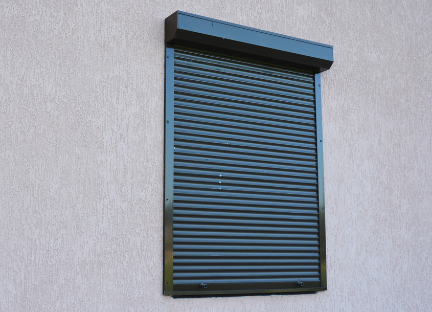 A close-up on house window with outdoor pvc roller blinds, motorized window roller shutters.
